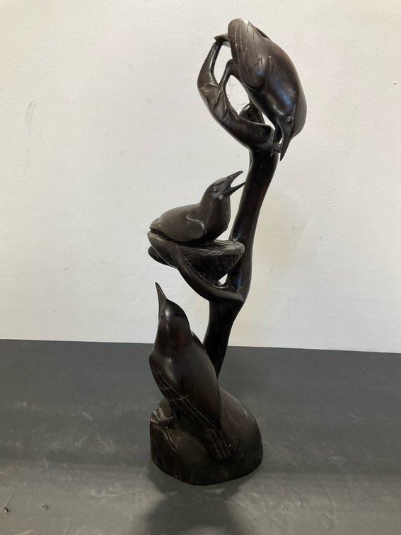 Carved dark wood birds on branch sculpture