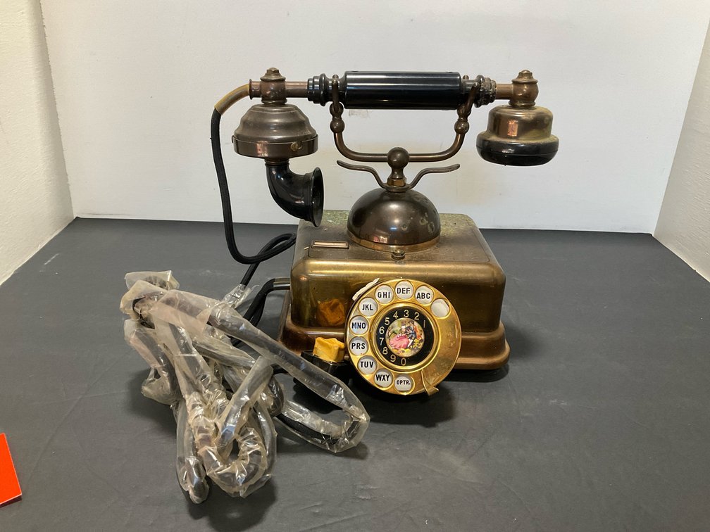 Brass-tone cradle rotary telephone with pictorial dial