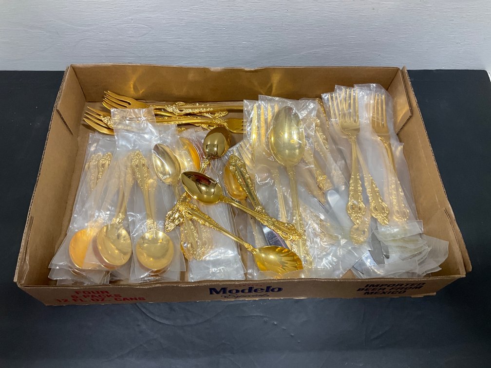 Grouping of gold-tone flatware with ornate scroll handles