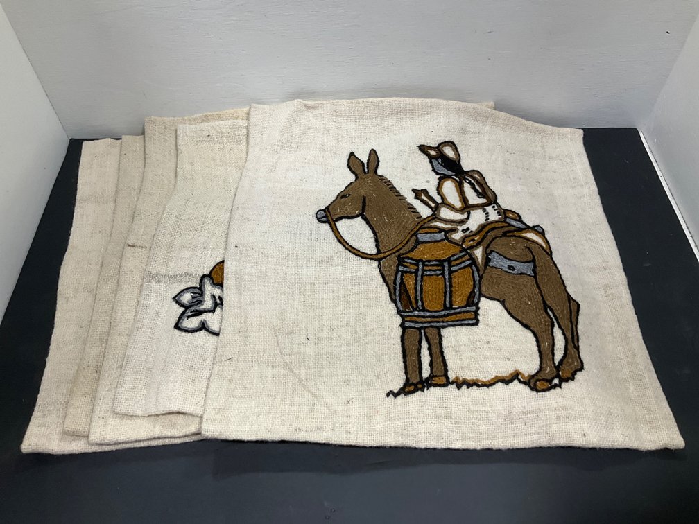 Grouping of embroidered woven cushion covers