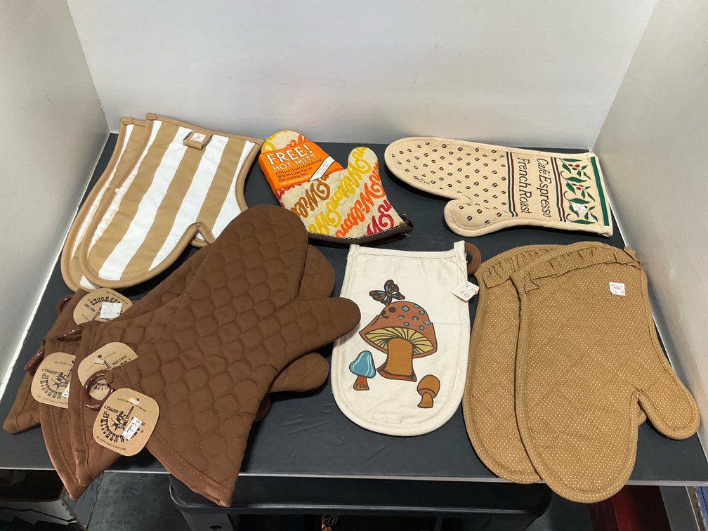 Grouping of assorted quilted fabric oven mitts