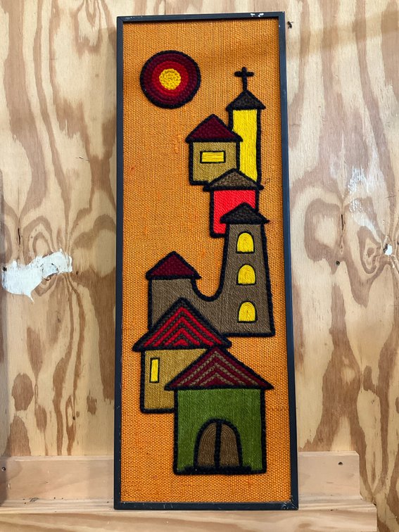 Framed yarn embroidery wall art on orange burlap