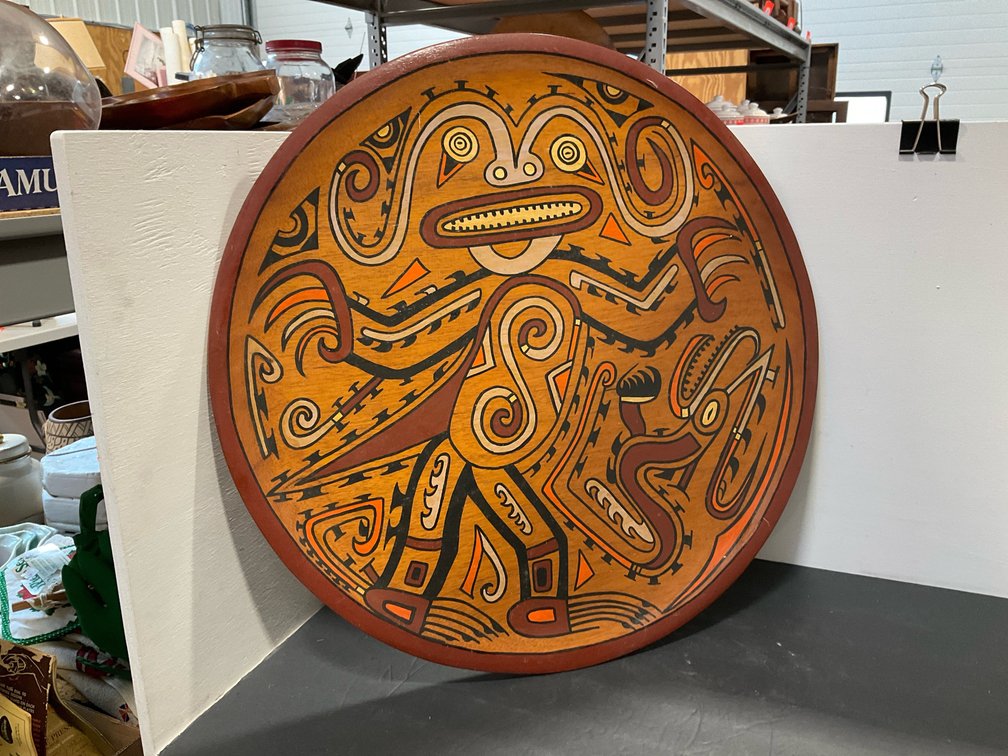 Painted wooden charger plate with stylized motif