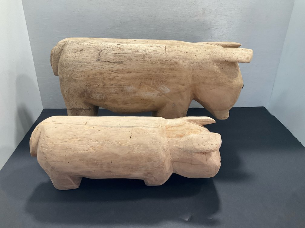 Pair of carved solid wood pig figures