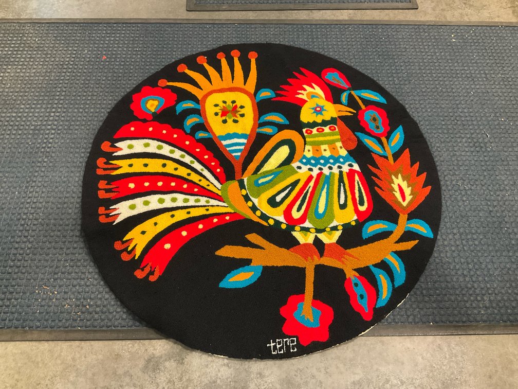 Circular folk art hooked rooster rug
