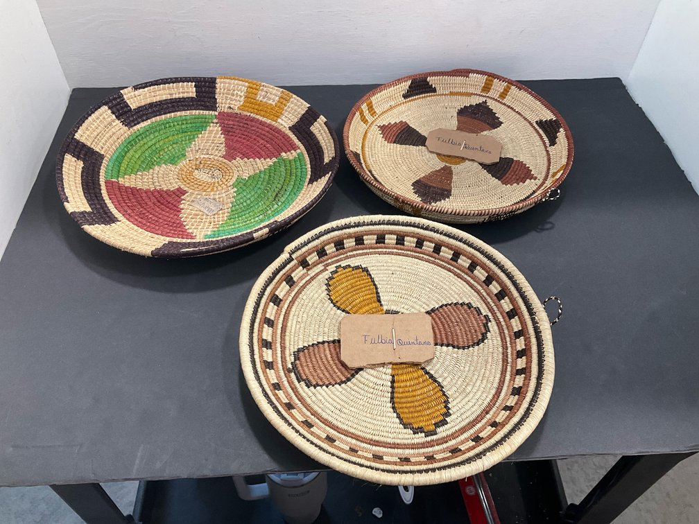 Coiled woven basket trays with geometric motifs