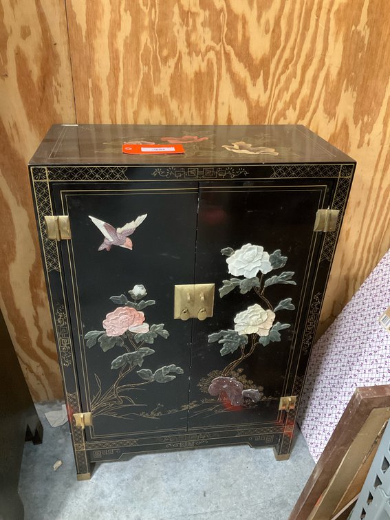 Black lacquer two-door cabinet with carved stone relief