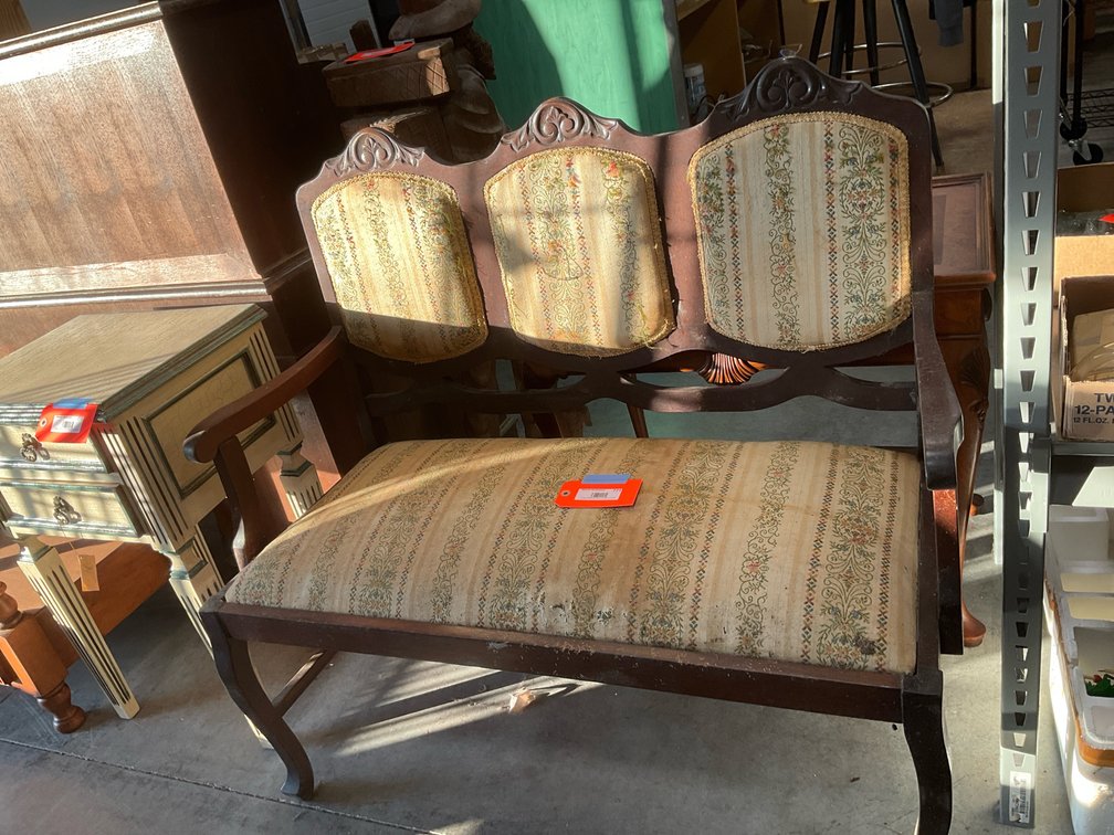 Carved wood settee with floral embroidered upholstery 43” x 20” x 41”