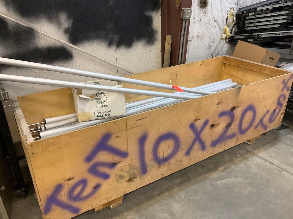 Large wood crate of aluminum tent poles 
