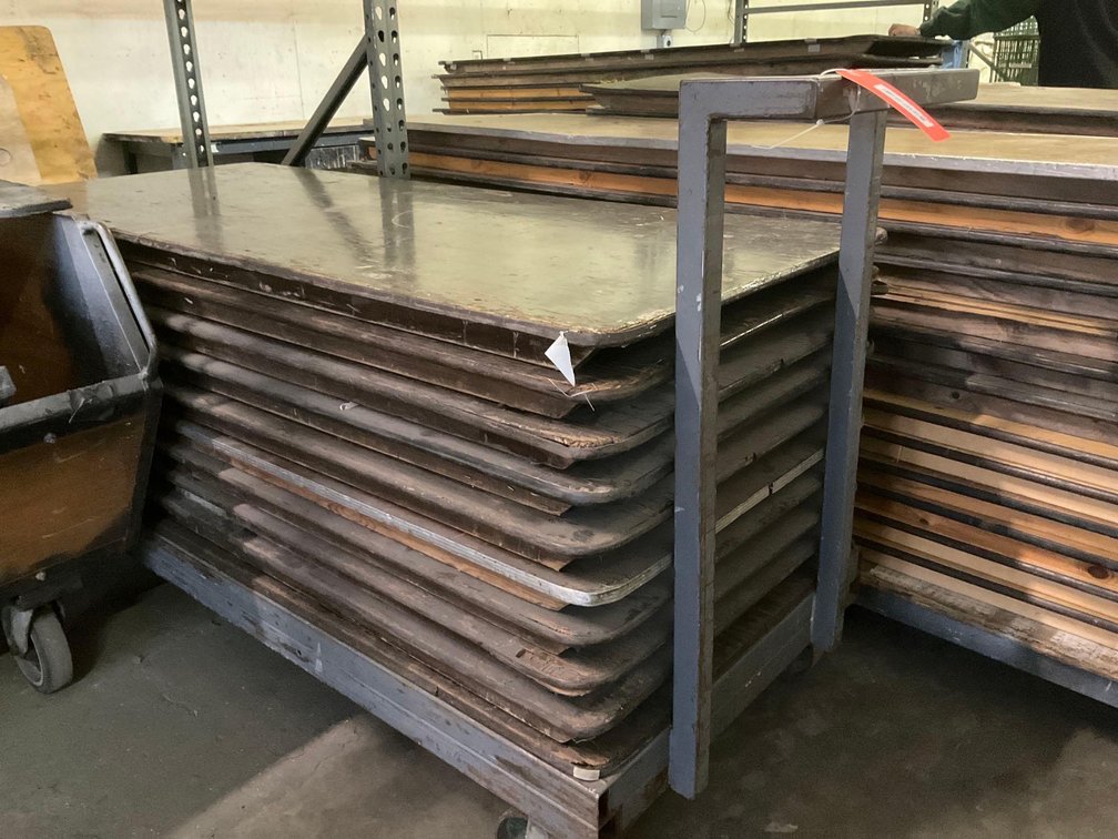 Stack of 6’ folding banquet tables & cart dolly