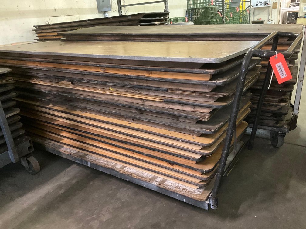 Stack of 8’ folding banquet tables & cart dolly 