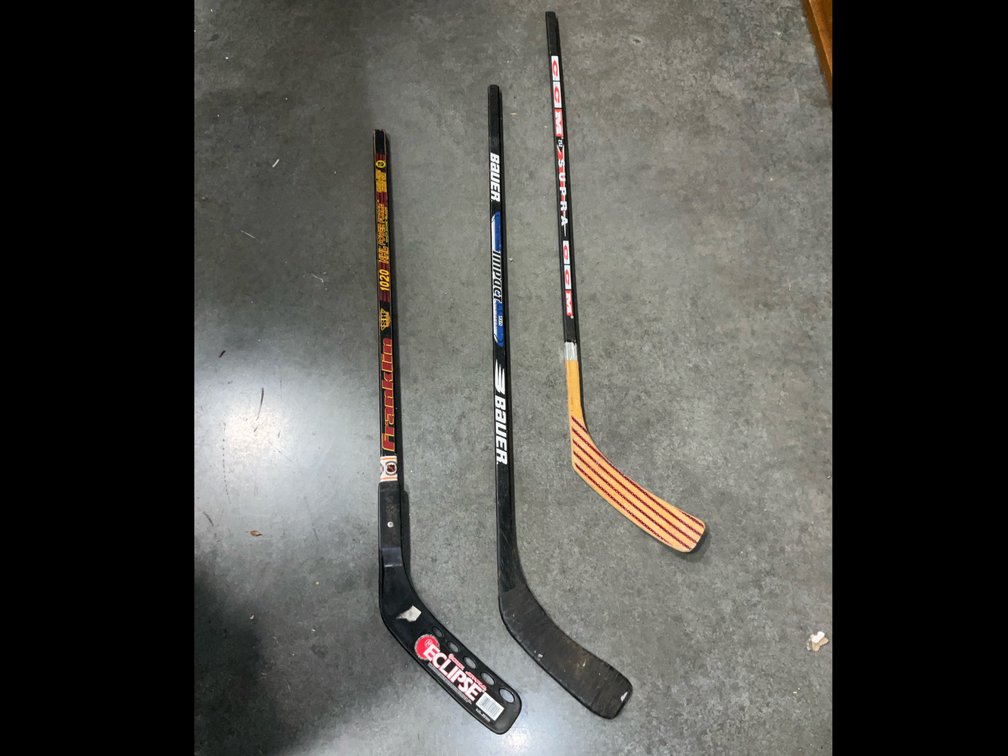 Three hockey sticks