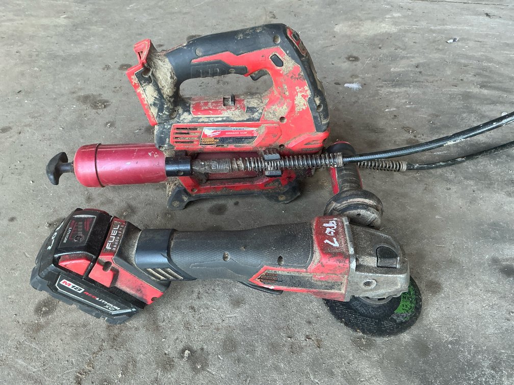 Milwaukee M18 Cordless Grease Gun and M18 FUEL Angle Grinder with Battery