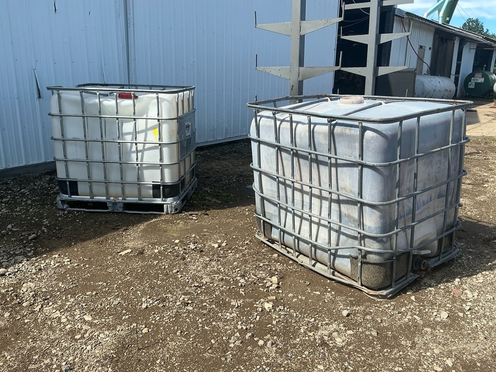 (2) 250-Gallon IBC Tote Tanks in Steel Cages