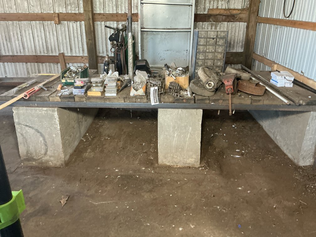 Shop Workbench with Roller Chain, Circular Saw, Welding Helmet, Bottle Jack, Hardware, and More
