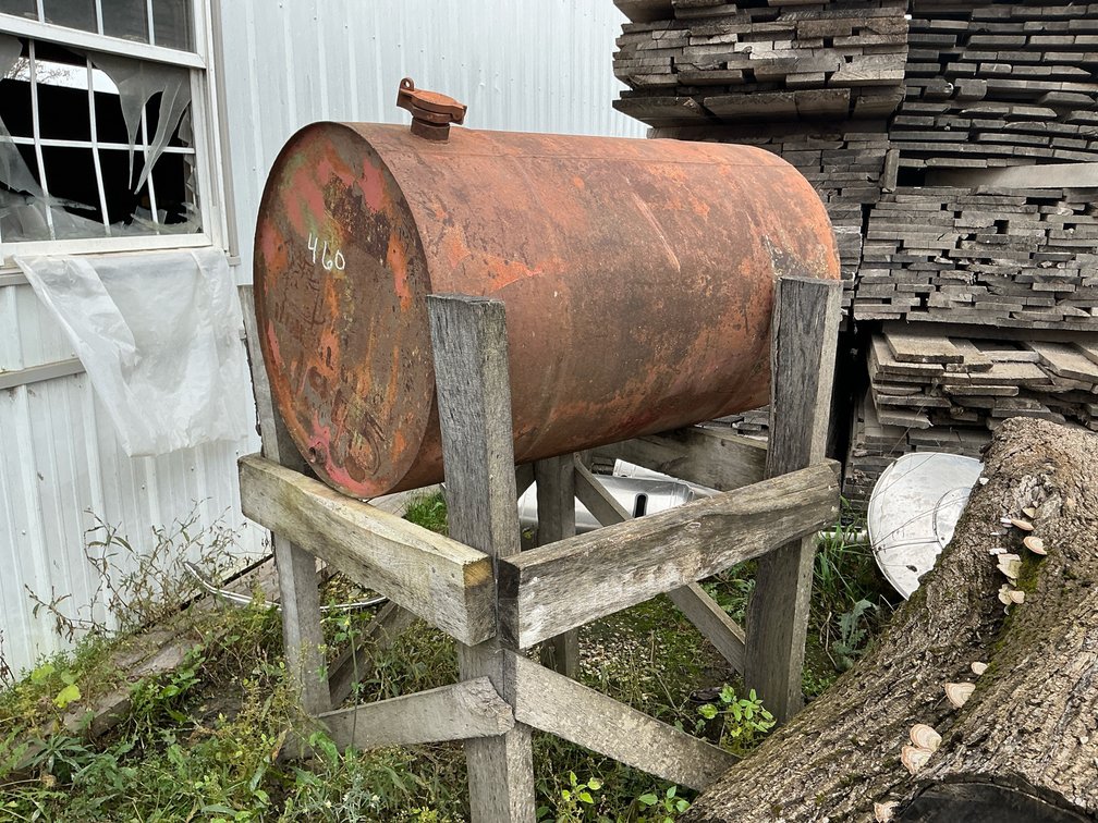 Horizontal Cylindrical Steel Storage Tank on Wooden Stand