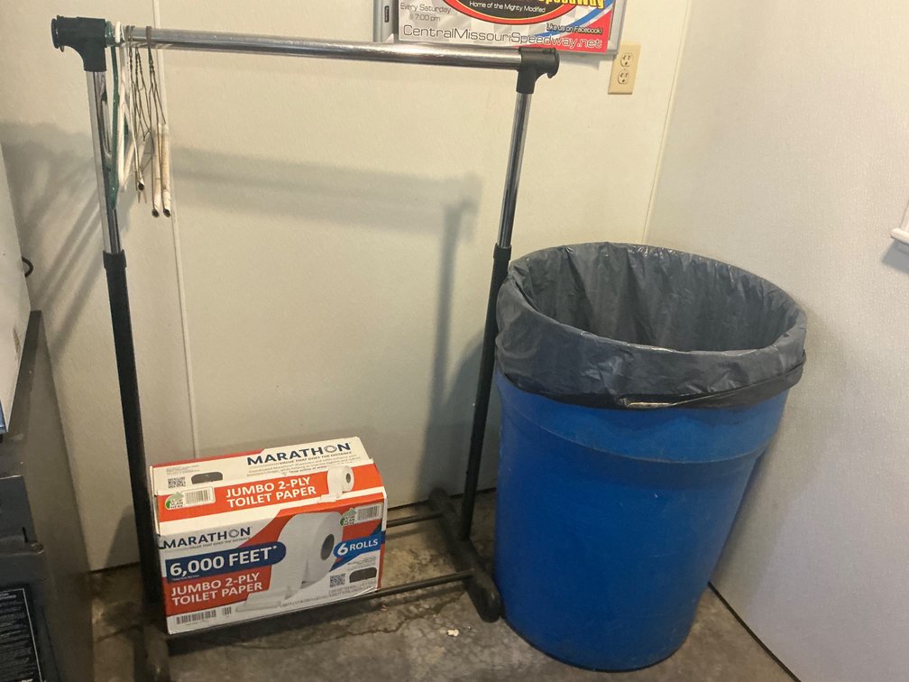 Garment Rack, Toilet Paper, And Trash Can