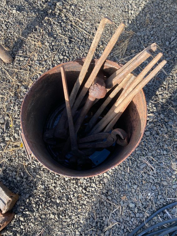 Metal Bucket with Blacksmith Tongs and Forging Tools