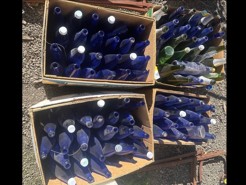 Four Boxes of Cobalt Blue, Green, and Clear Glass Bottles