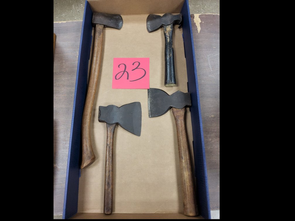 Assortment of camp axes and hewing or broad hatchets. 