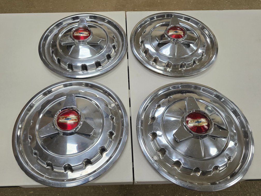 Set of 4 old & original 1957 Chevy Bel Air Spinner Hubcaps