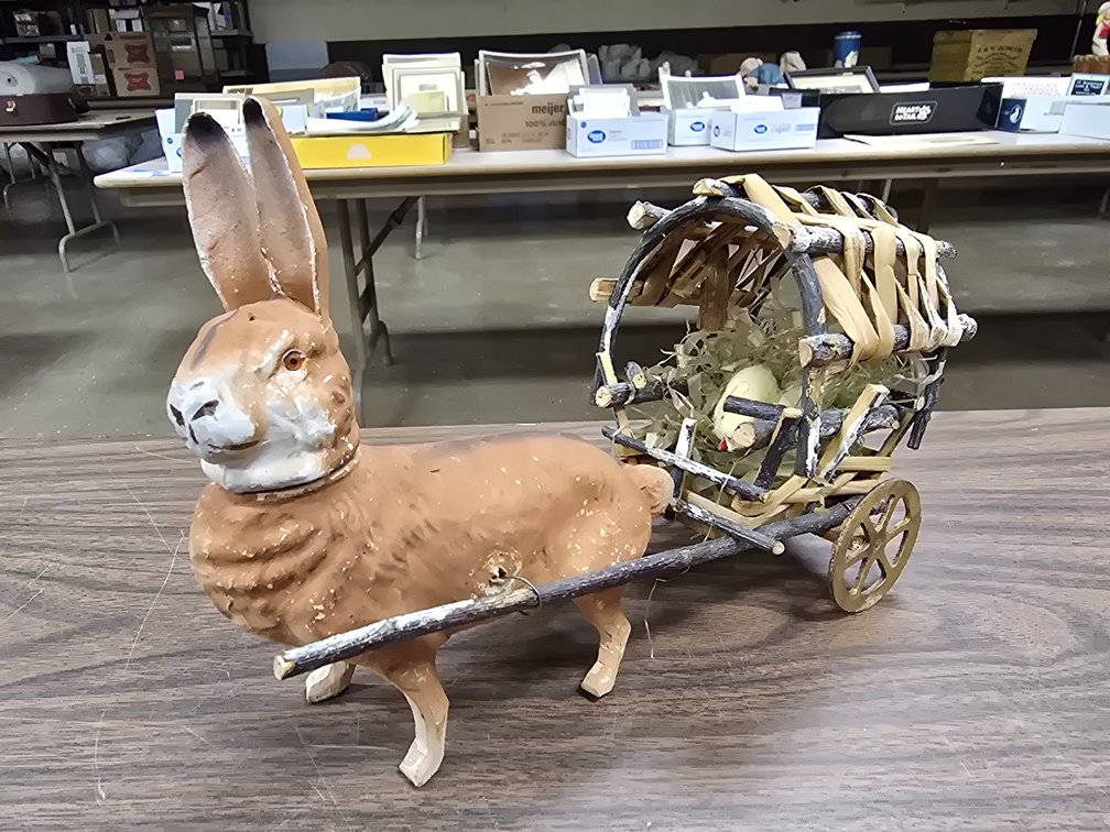 German mache Easter rabbit with chick in wagon.