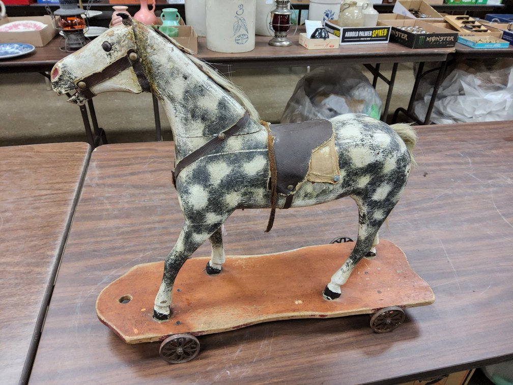 Carved wood pull horse on platform