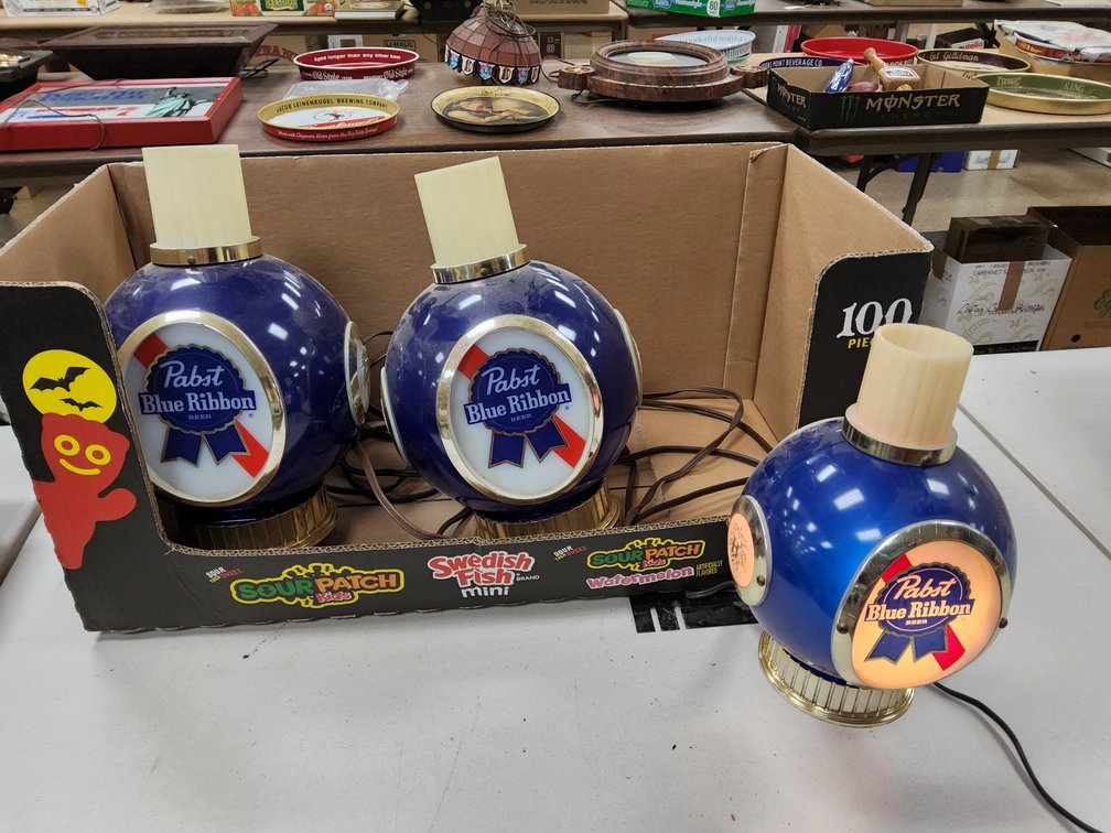 Two Pabst sconce lights and a register lamp.