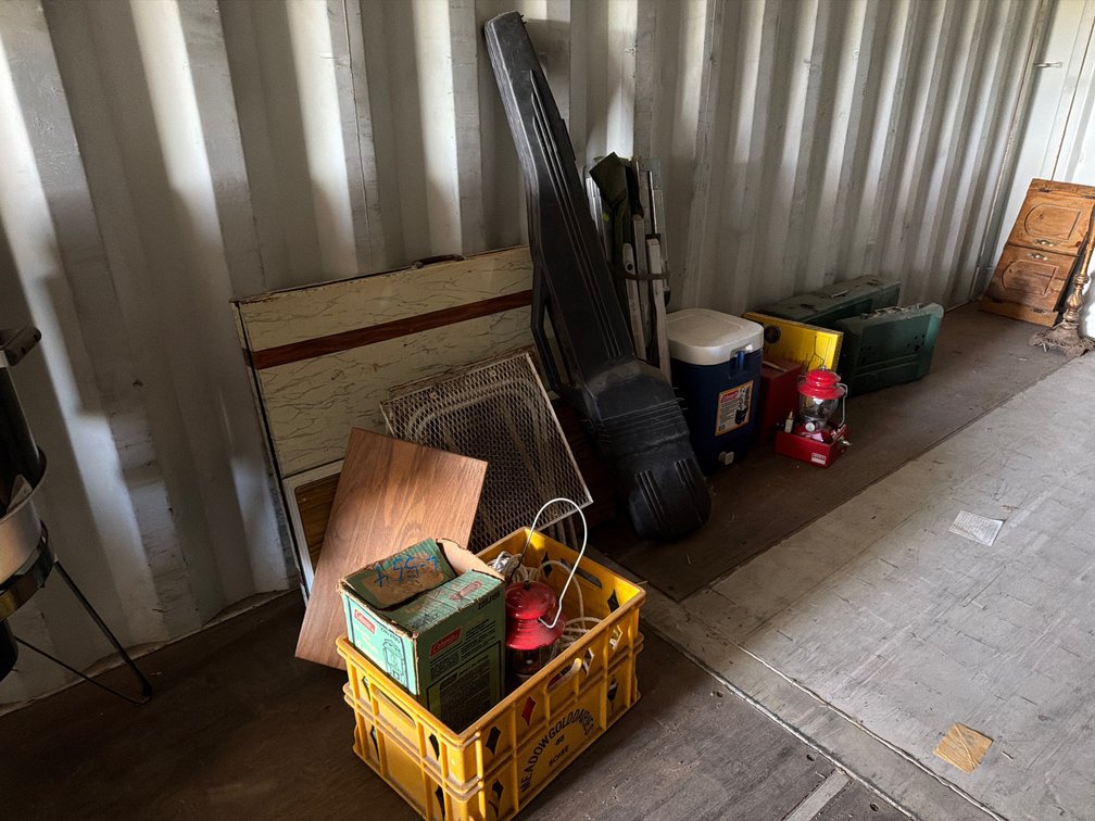 Coleman lanterns, stoves, camp table, cot, water cooler