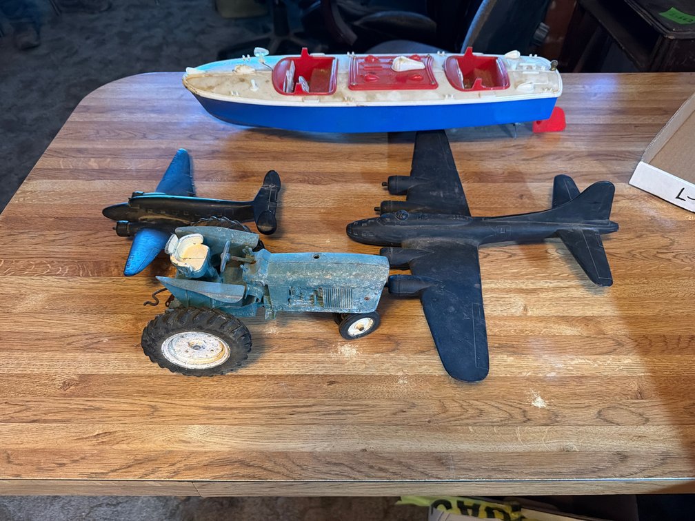 toy tractor, boat, airplanes