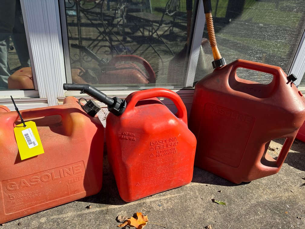 Three Red Plastic 5-Gallon Gasoline Cans