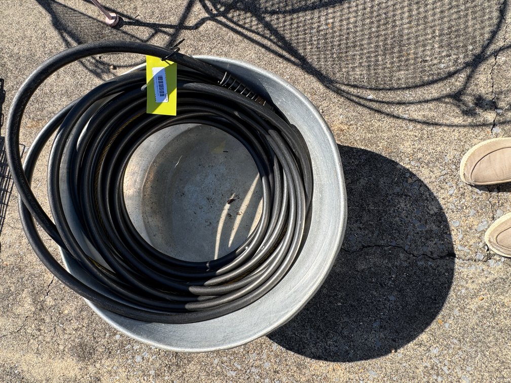 Coiled Black Hose in Galvanized Metal Basin
