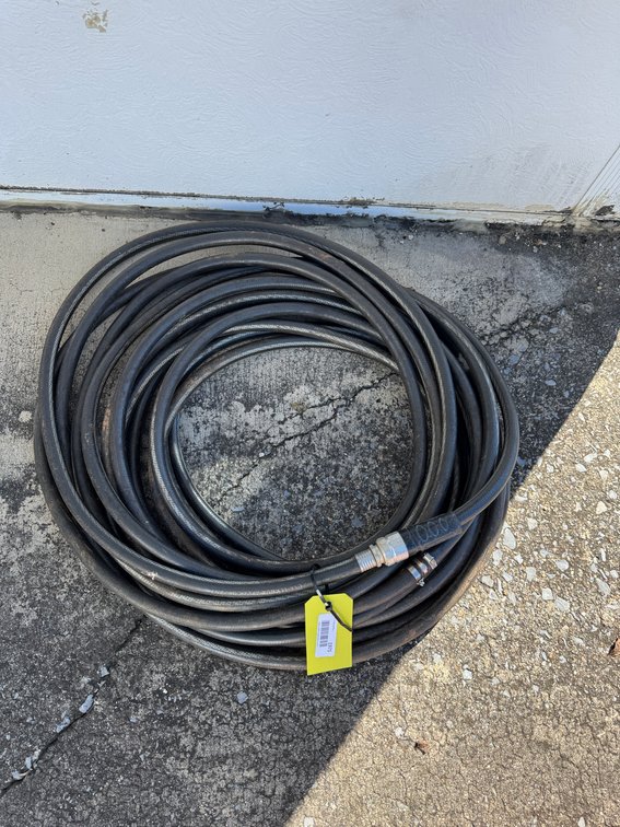 Coiled Black Industrial Hose with Metal Fitting