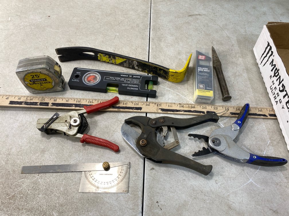 Hand Tools Including Tape Measure, Pry Bar, and Level