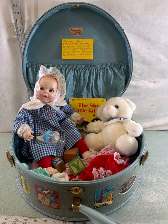 Round Suitcase with Baby Doll, Plush Bear, and Book