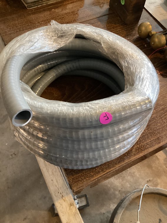 Almost full roll of plastic hose