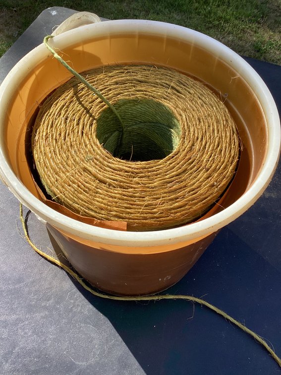 Almost full roll of twine in bucket