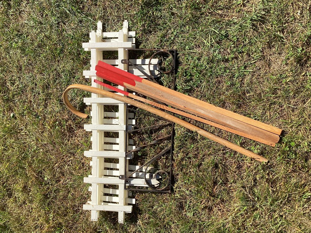 Plastic fencing, small steel gate, wood stakes and a cane