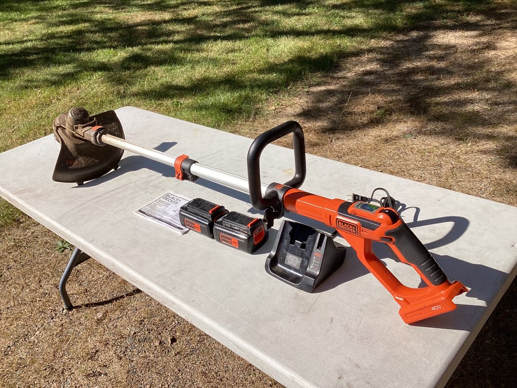 Black and Decker 40 volt trimmer with 2 batteries and book