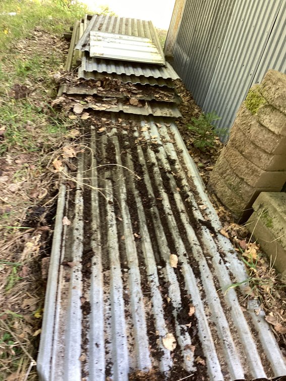 Stack of old style tin in various lengths