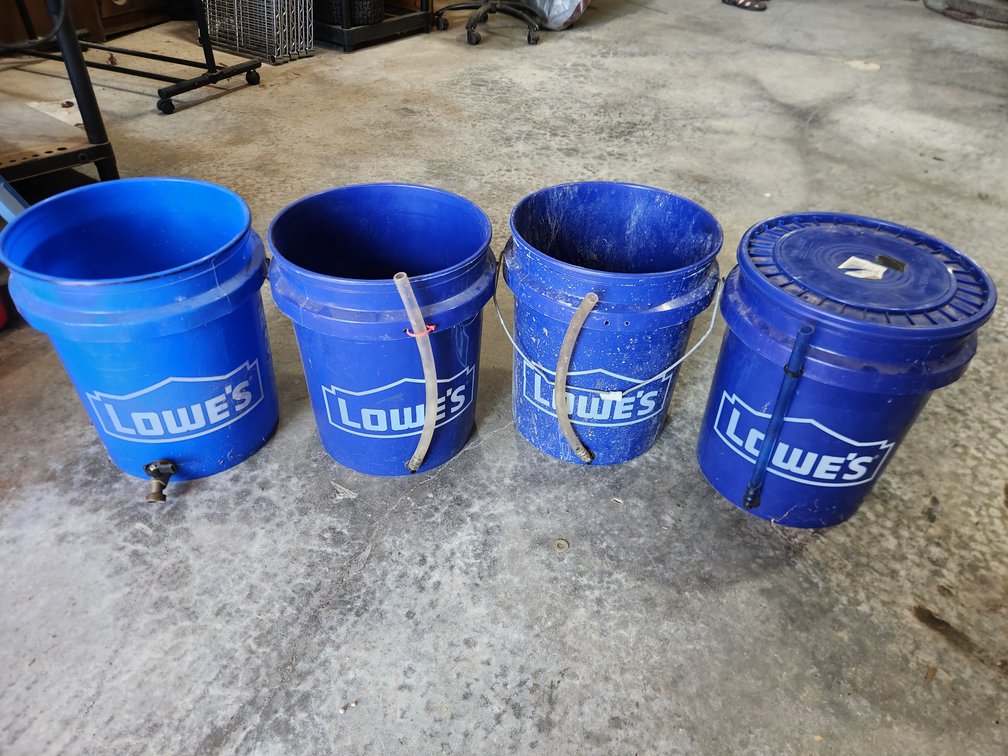 Lot of Buckets with Spigots and Hoses
