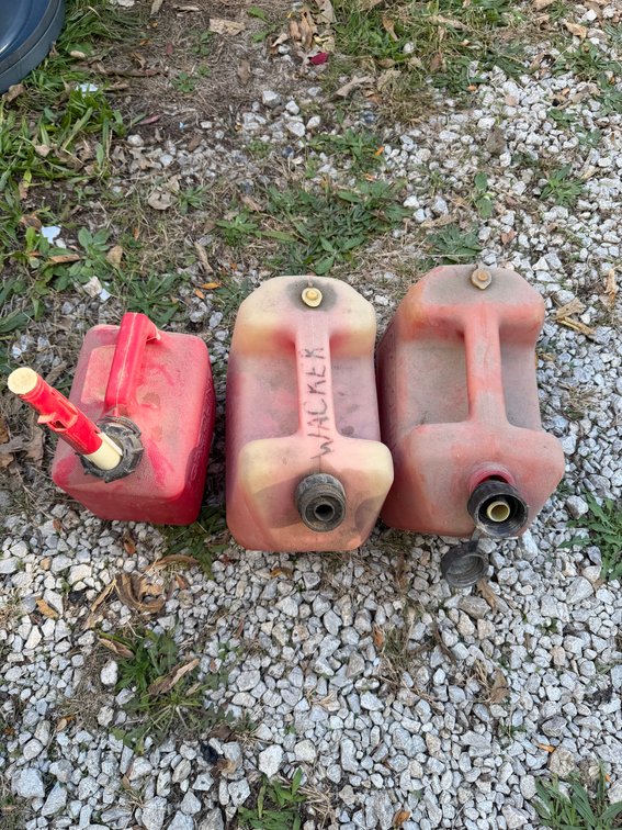 Three Red 2 gallon gas containers