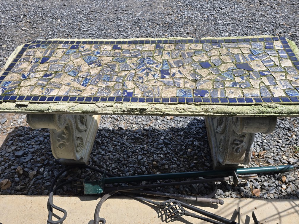 Plaster yard bench with mosaic tiles