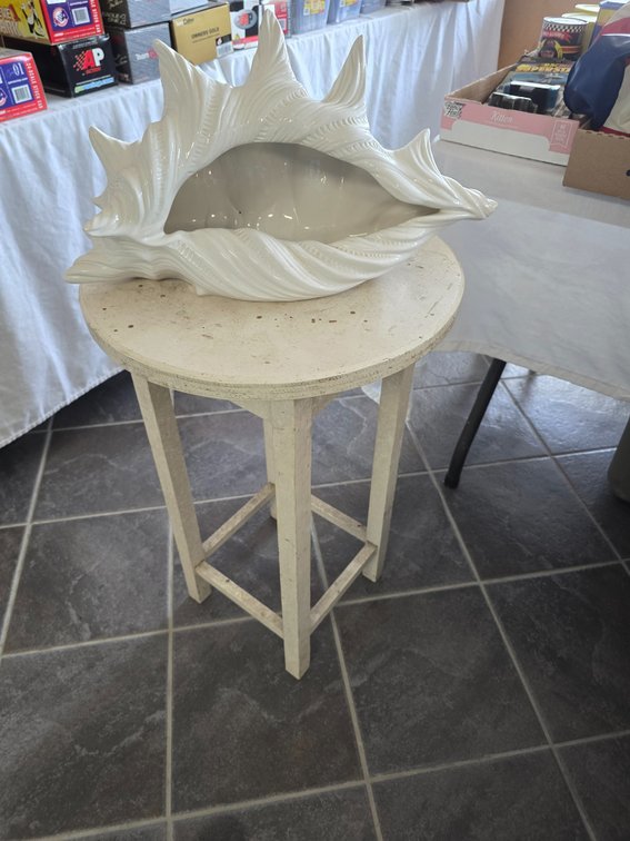 Round wooden table with sea shell planter