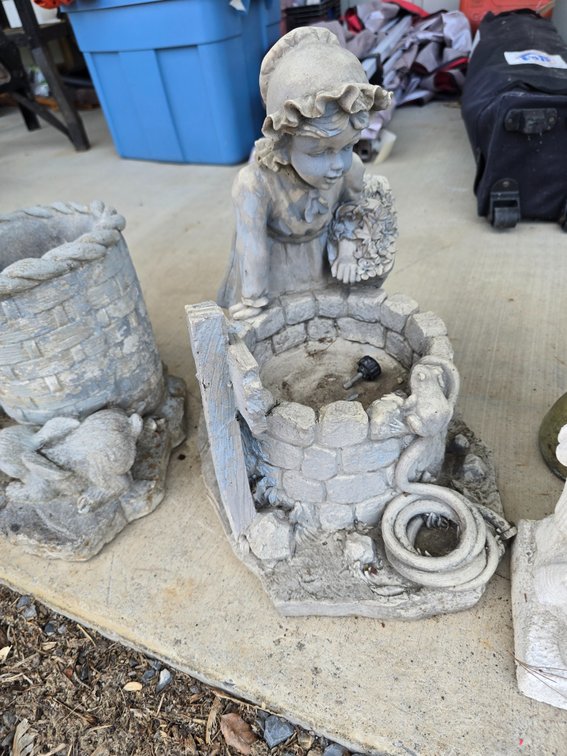 Concrete little girl with wishing well