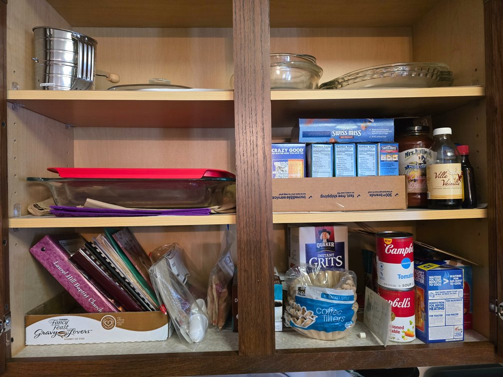 Kitchen items, including pyrex dishes, cookbooks and foods