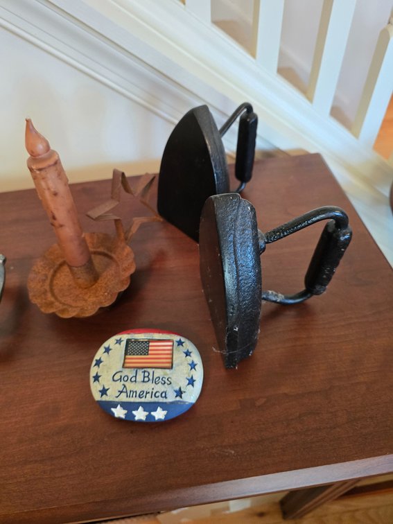 2 irons, painted rock and primitive candle
