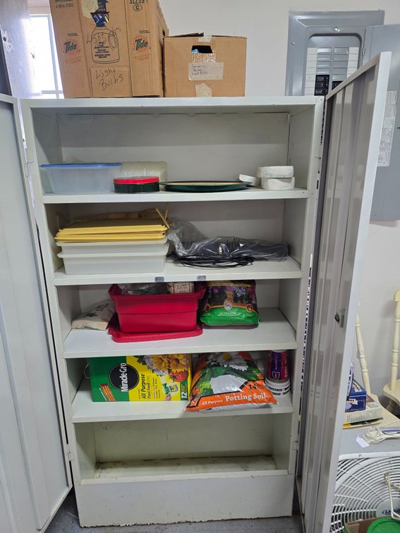 Metal Cabinet with lots of gardening supplies, ect
