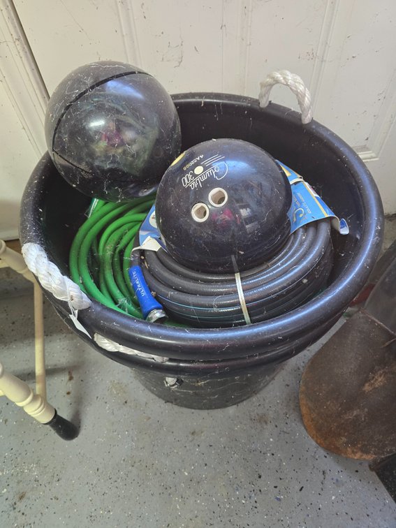 2 Tub of watering hoses and two bowling balls