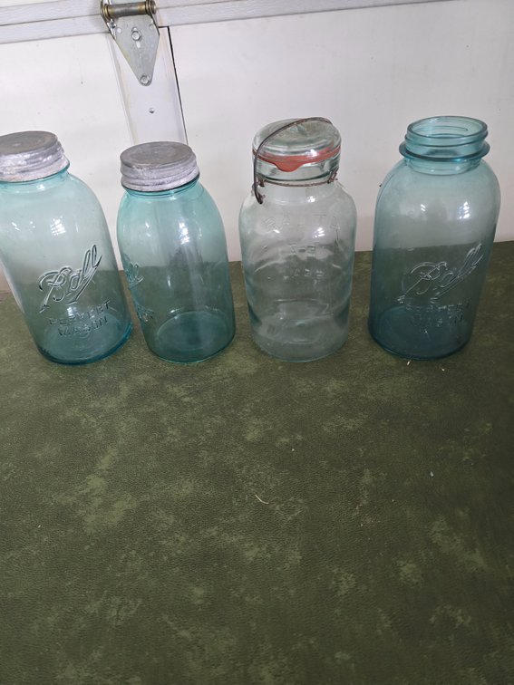 Four blue half gallon jars, with zinc lids and one glass lid